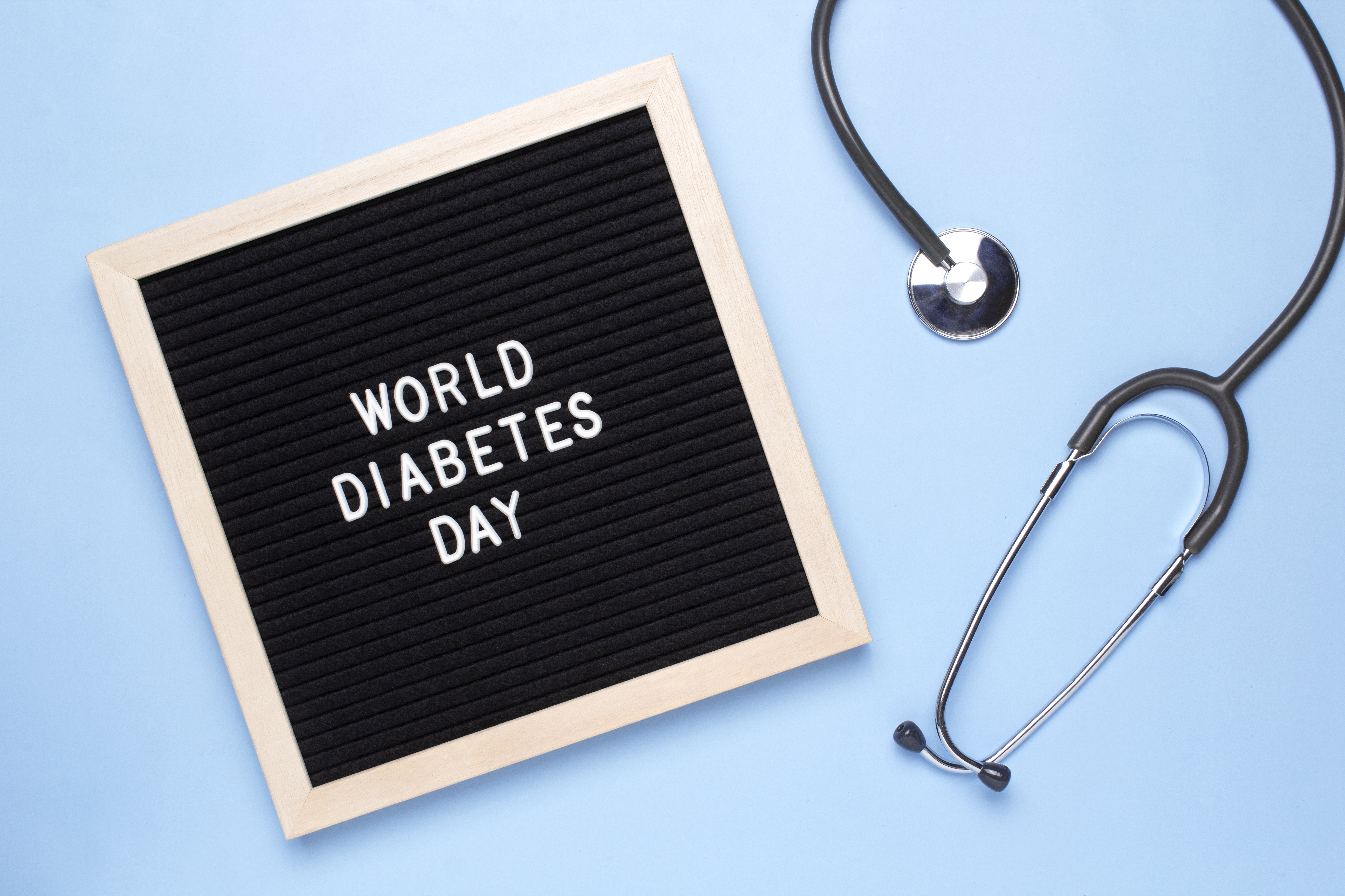 inscription world diabetes day and stethoscope on a blue background. World diabetes day,14 november.